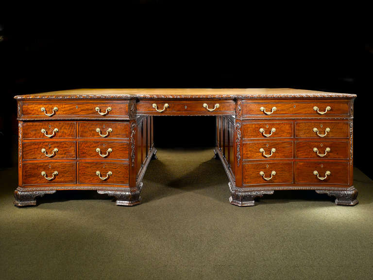 Unrivaled in size and quality, this extraordinary antique mahogany partner’s desk is simply the most spectacular we have ever seen. Exhibiting beautiful proportion, it measures over seven feet wide and six feet deep, and is crafted entirely of the