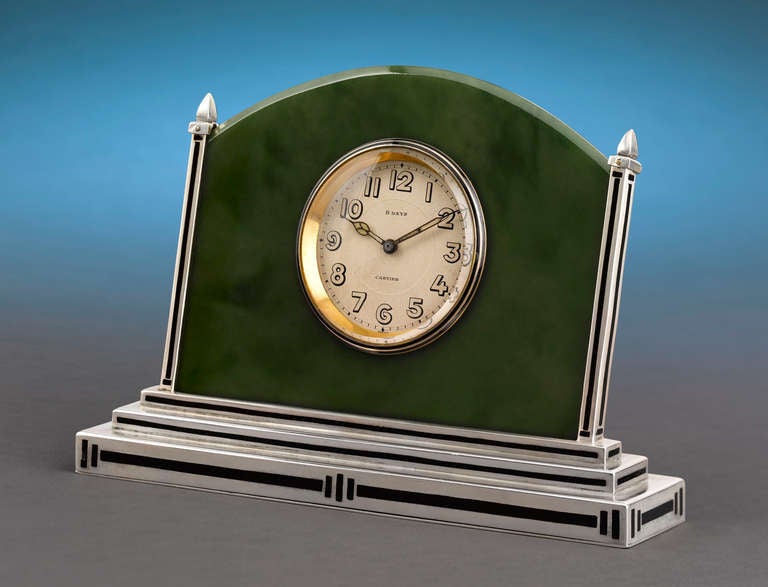 This stunning Cartier Art Deco clock exhibits an undeniable elegance. Crafted of a plaque of exquisite jade set into a frame of enamel-accented silver, this wonderful 8-day clock would have been at home in the most stylish of offices or homes. Art