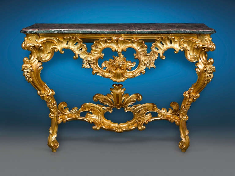 This outstanding Louis XV-period giltwood console table is lavishly carved with the naturalistic, voluptuous motifs. The console table reached the height of fashion during the Louis XV period and, in keeping with decorating dictates, they were often