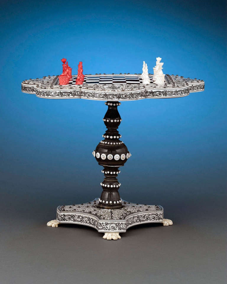 This enchanting Anglo Indian miniature chess table is exquisitely carved with tortoiseshell and horn.  Produced in the region of Vizagapatam in the second quarter of the 19th century, this lovely veneered table has a petal-shaped outline with