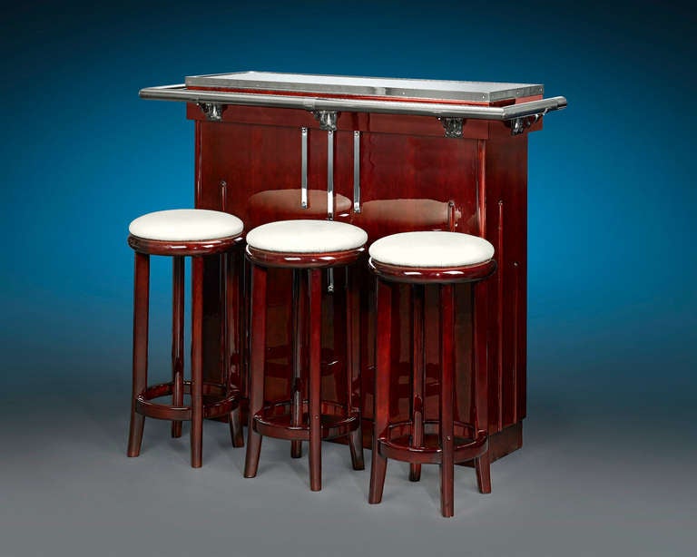The elegance of the Art Deco style is epitomized in this stunning French bar. Boasting the sleek sophistication of the Jazz Age, this bar is beautifully crafted of lacquered mahogany mounted with polished chrome accents, including a handrail and a