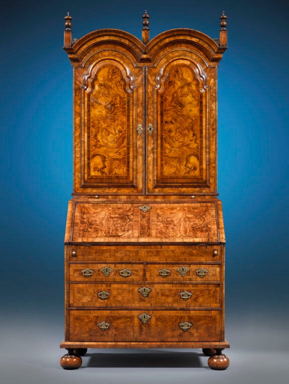 Queen Anne-period furnishings such as this burl walnut secretary are incredibly rare and important examples of English cabinetmaking. This secretary is of the most outstanding caliber, boasting desirable double bonnet cabinet doors, bun feet and its