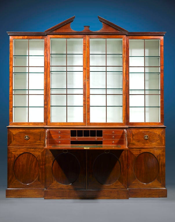 This outstanding George III-period breakfront is attributed to Gillows of Lancaster, England. Crafted of luxurious Cuban mahogany, this breakfront features the architectural elements of the finest English furnishings, including a broken arch