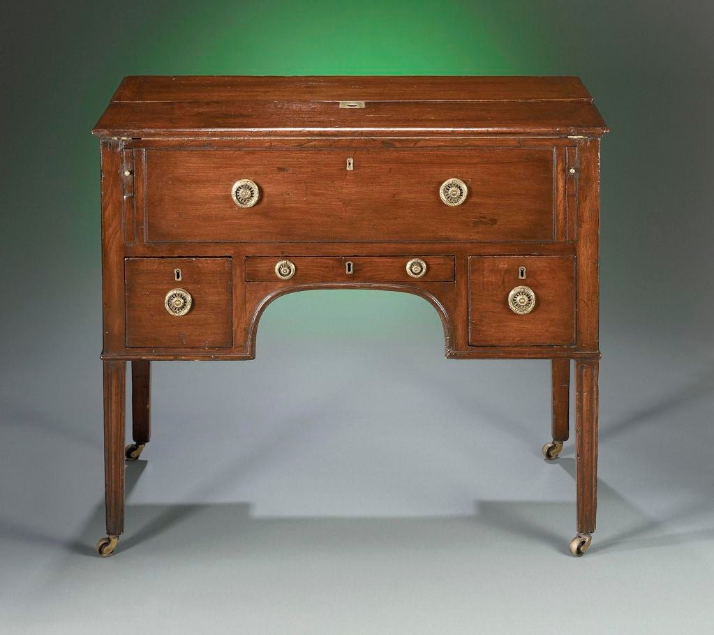 This outstanding George III mahogany mechanical desk is equipped with a leather writing surface and fully-fitted suite of drawers and compartments, which pops up when the desk is opened. Inspired by military Campaign furniture, which was designed to