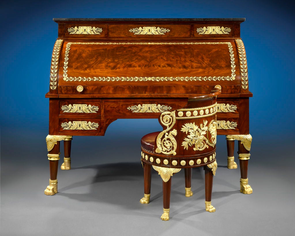 The finest ormolu fixtures swathe this Restoration-period roll-top desk (bureau à cylindre) and (fauteuil de bureau) swivel desk chair, both crafted of fine Cuban mahogany. The desk is appointed with a fitted interior of compartments, lockable