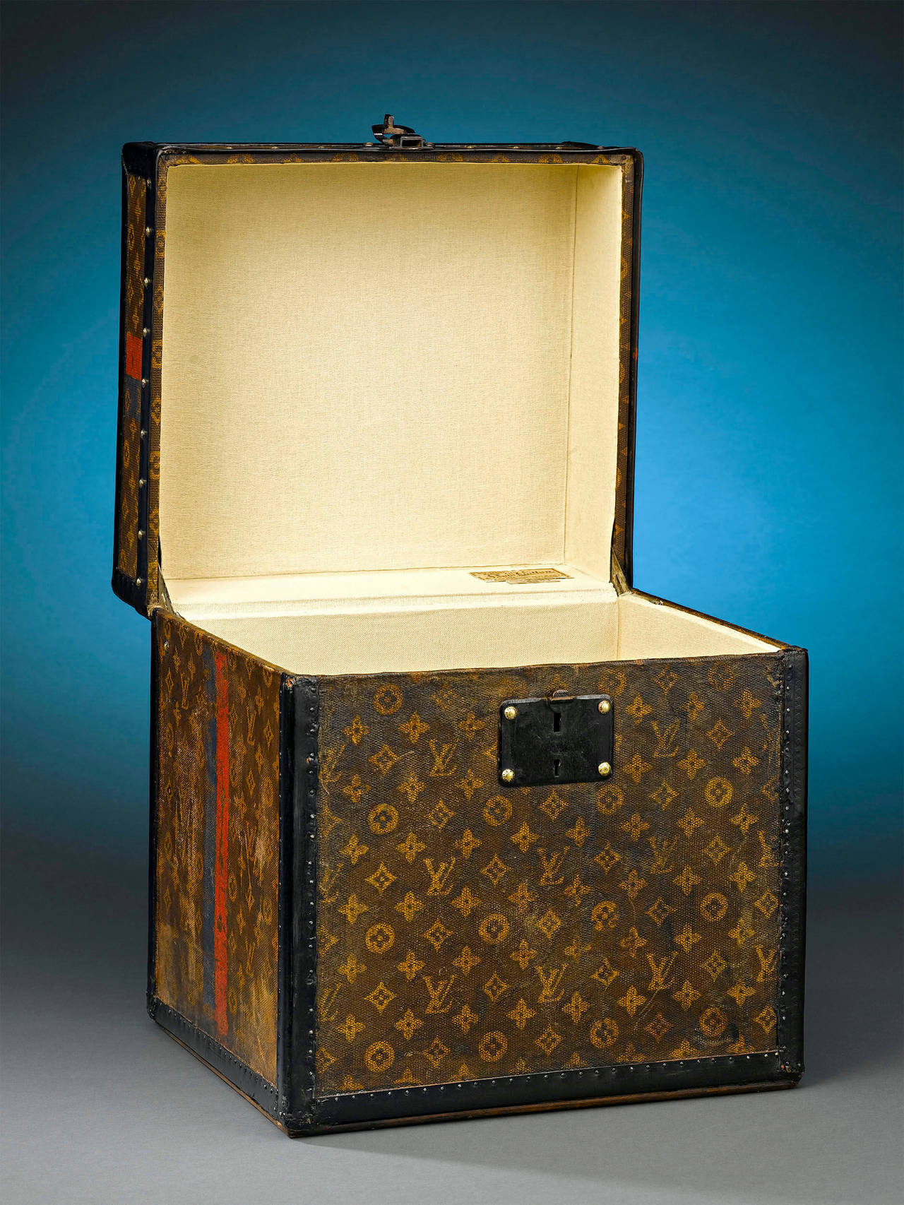 This rare antique Louis Vuitton hat box embodies the elegance and sophistication of a bygone era. Boasting the iconic “LV” monogram on its leather-upholstered frame, this standing box is designed for transporting one’s hats and accessories, and its