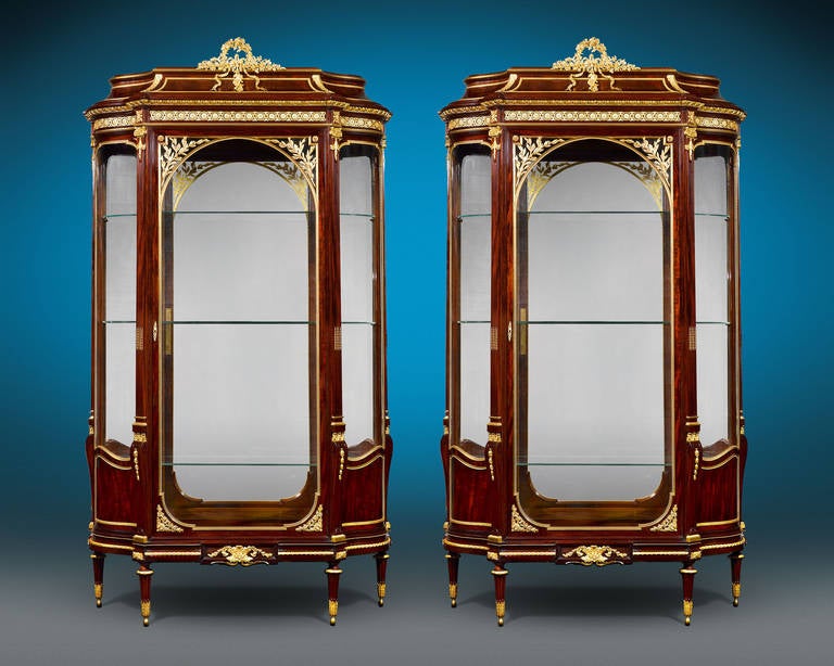 Superior craftsmanship and elegant adornment characterize this exceptional, matching pair of mahogany vitrines by François Linke, the most influential and distinguished French ébéniste of his time. Credited for designing highly innovative