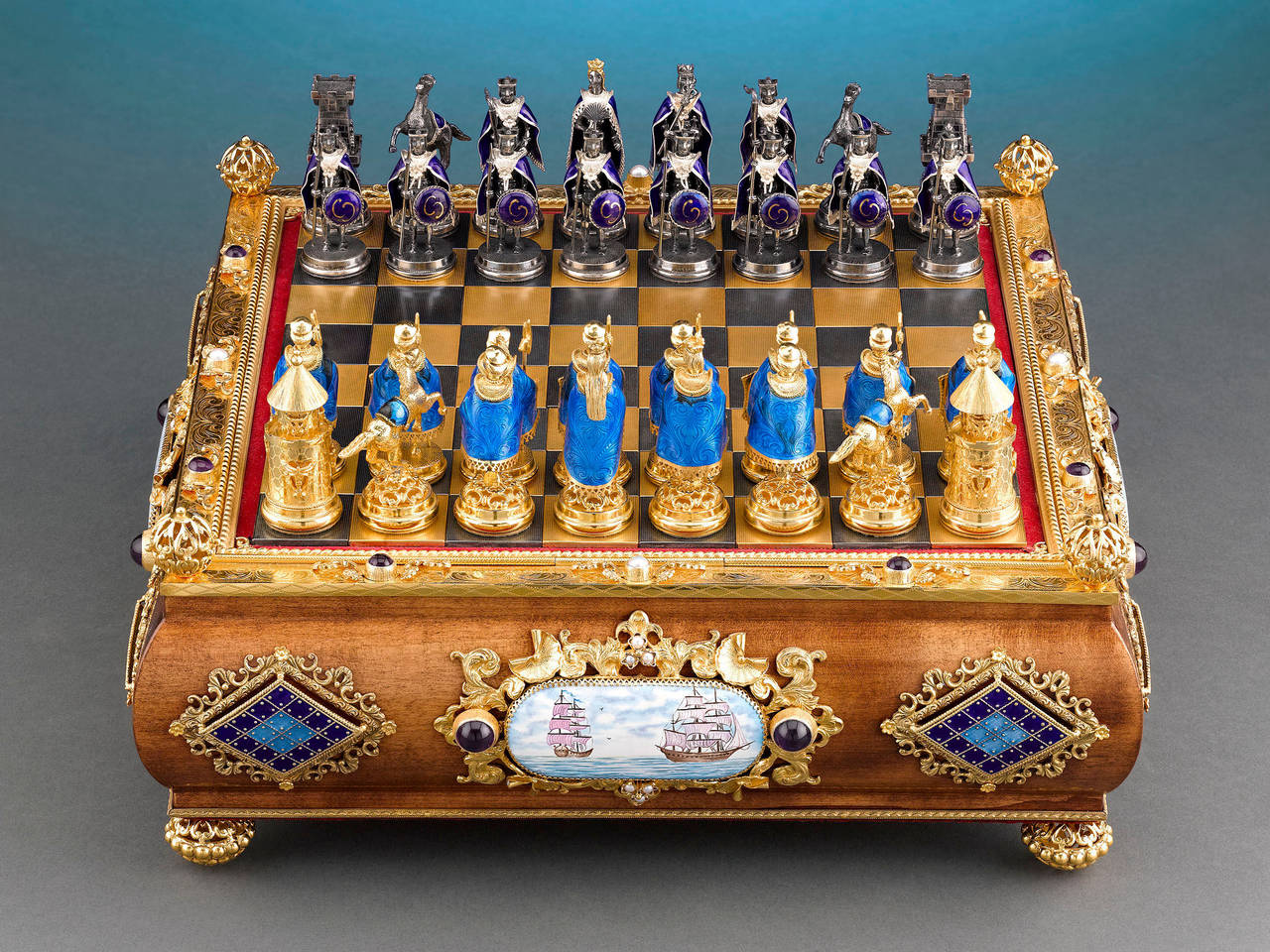 Two medieval armies square off in this magnificently crafted Austro-Hungarian silver gilt chess and enamel set. The game pieces are cloaked in vivid purple and blue guilloché enamel and feature silver and silver gilt bodies, respectively, to