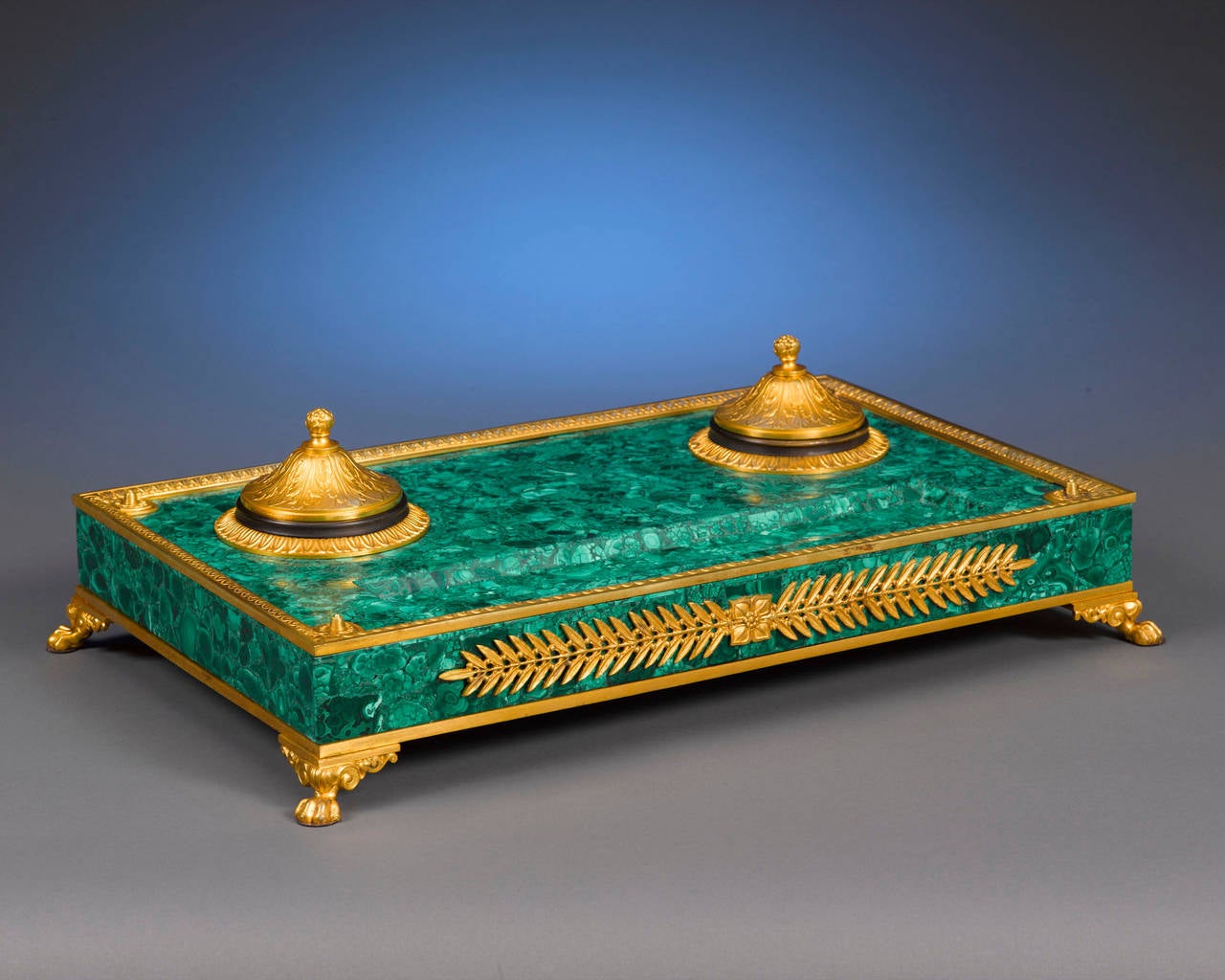 Malachite is one of Russia’s most prestigious stones, and its use in the creation of this rare and opulent inkwell indicates commission and ownership by an individual of considerable status. Wonderful doré bronze accents are the perfect complement