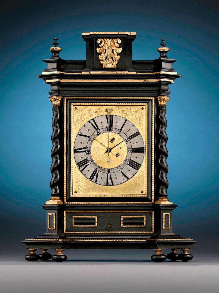 This elegant Southern German table clock boasts a stately silhouette that would be a splendid addition to any mantel. A beautiful fusion of form and function, this attractive mantel clock was created by one of the most renowned clockmakers in