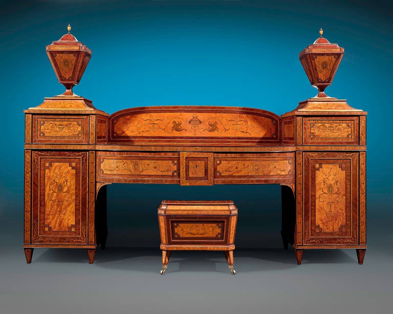 This magnificent monumental sideboard is a stunning masterpiece of artistry and craftsmanship. Constructed of high quality satinwood boldly crossbanded with rich mahogany, this stunning sideboard embodies the neoclassical Adams Style. Lockable