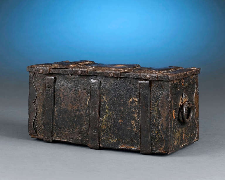 This fascinating Continental wrought iron strong box was intended to secure one's most precious valuables while traveling. The strap work and well-engineered locking mechanism served to make this case virtually indestructible. Although made
