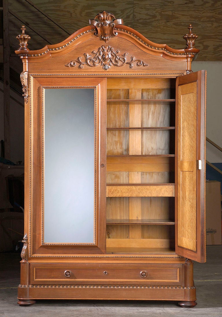 A magnificent American rosewood armoire of grand proportion and design with double-mirrored doors. Attributed to New Orleans cabinet maker Prudent Mallard, this armoire is a superb example of hand-crafted American furniture of the Civil War era.