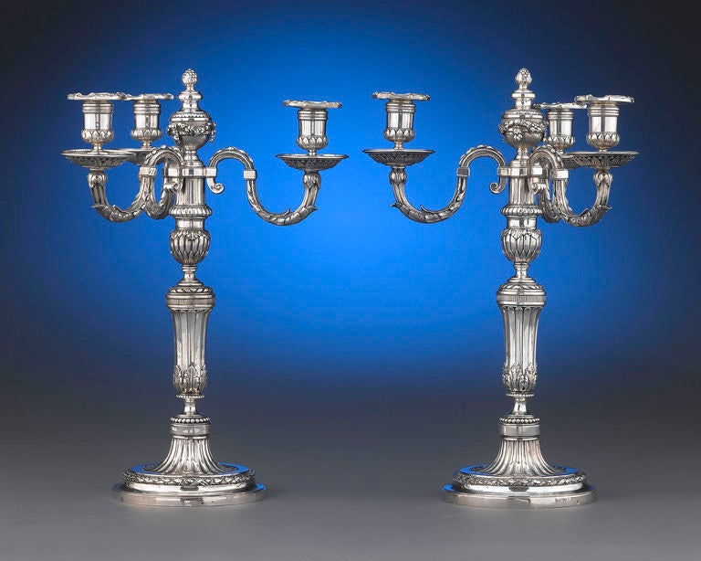 A stunning pair of period Louis XVI three-light silver candelabra, each bearing the mark of Jacques-Charles Mongenot. Exhibiting the architectural Neoclassical style that defined this period, these candelabra are crafted with exceptional detail,