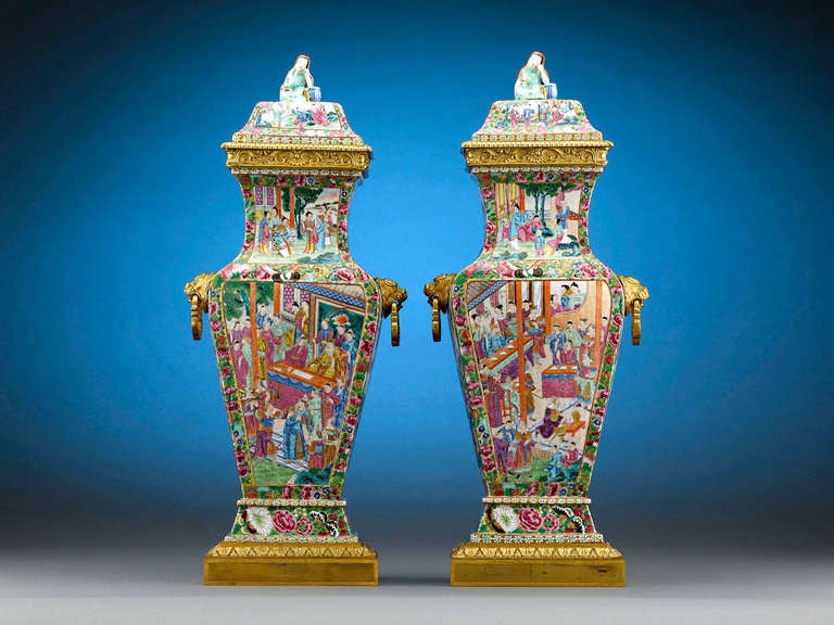 This fine pair of stunning Chinese export porcelain urns is decorated in the Famille Rose style. Developed as export items to please European consumer's ever increasing desire for Chinese porcelain, the Famille Rose decorative style was initially