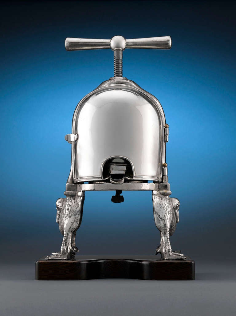 This curious silver plate mechanism, crafted by the renowned Joseph Heinrichs, is known as a duck press, or <em>press à canard</em>, and was once an indispensable element of French cuisine. Used for squeezing the juices out of a duck carcass in