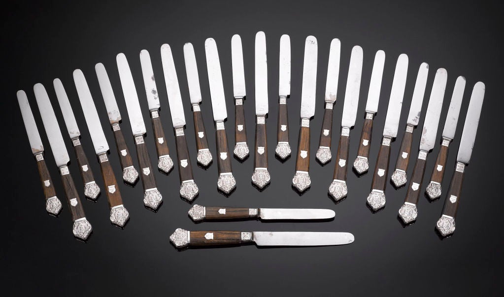 The stuff of nursery rhymes, this handsome and rare English set of 24 knives was crafted of oak timber taken from the first stone version of the famed London Bridge. Crafted by Weiss of London, the knives are beautifully decorated with repoussé