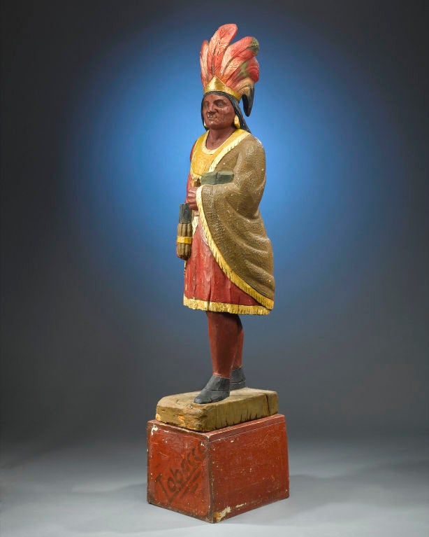 A magnificent piece of Americana, this marvelous cigar store chief, possibly by master carver Samuel A. Robb, is a wonderfully preserved example of the time-honored art of American wood carving. Dressed in a red and gold tunic and wrapped in a