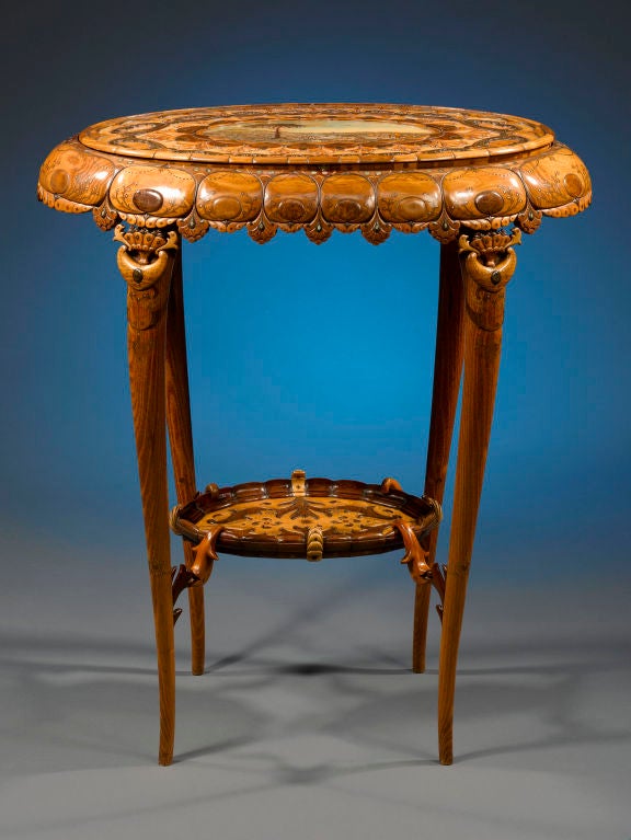 This incredible Art Nouveau worktable is a one-of-a-kind tour de force of French cabinetmaking. The entire piece is handcrafted of a multitude of fine-grain fruitwoods carved, layered and inlaid into an elaborate and exquisite organic motif. A
