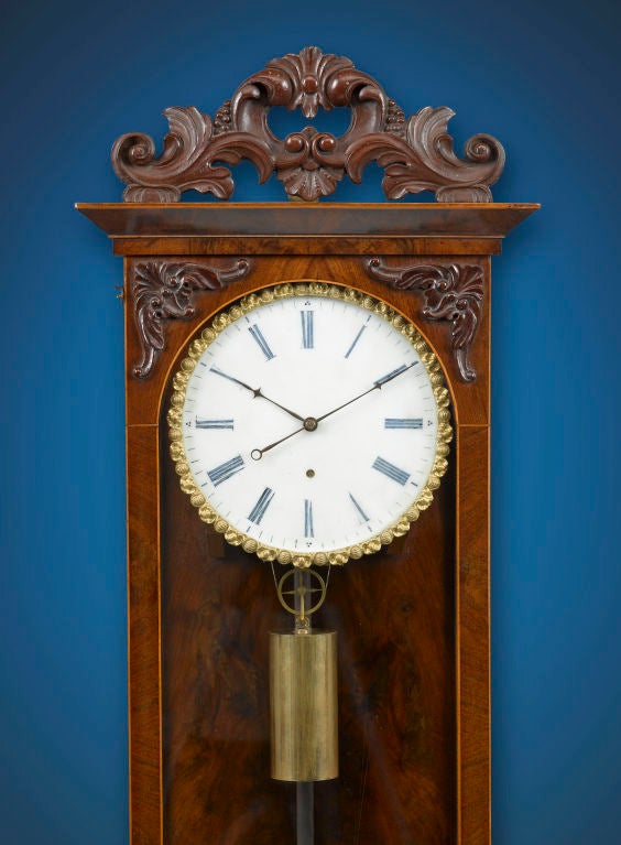 This elegant Biedermeier 30-day regulator clock beautifully demonstrates the precision and superiority of Viennese craftsmanship. The elegant inlaid case, crafted of the finest mahogany with hand-carved moldings, houses a dead beat escapement with a