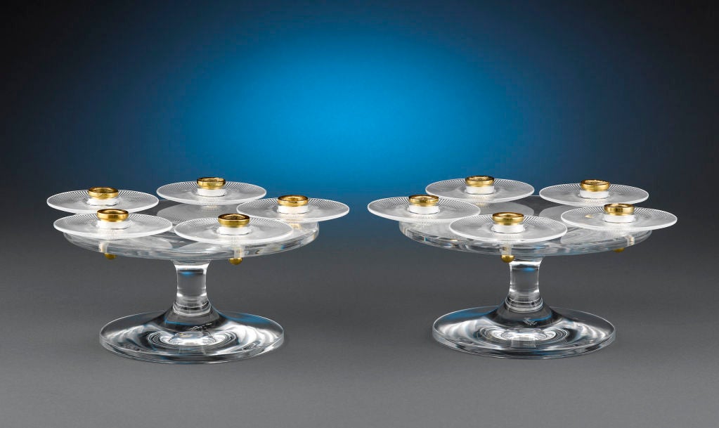 A rare and striking pair of Lalique crystal candelabras designed by Marc Lalique, marked with the signature grace and elegance for which the Lalique name is known throughout the world. Crafted in a distinctive tazza form, these five light