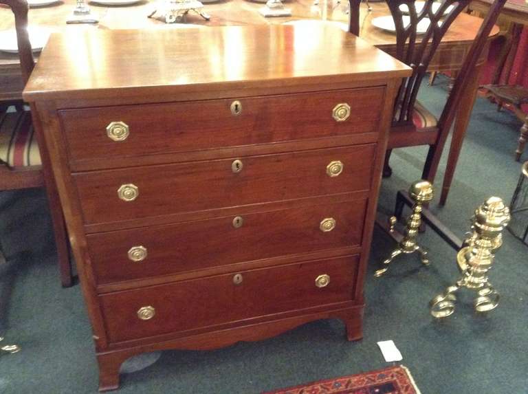 Handsome Heppelwhite Style four drawer bachelor's chest  with original hardware on French feet. This chest we believe was custom made is of high quality with wonderful proportions.