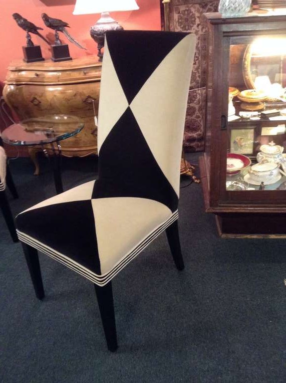 Wonderful pair of harlequin upholstered side chairs in black and cream velvet with amazing stripes around the seat front. These chairs are very High style and quite glamorous and dramatic.  The chairs have a plain cream velvet upholstered back and