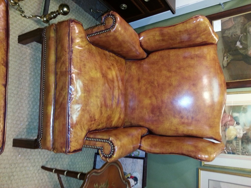 High quality leather Wingback Chair with matching Ottoman in a rich shade of brown with great nail head trim. The chair and Ottoman both have mahogany legs and frame. This is the Perfect set for any library or office. 

Dimensions of ottoman are: 
