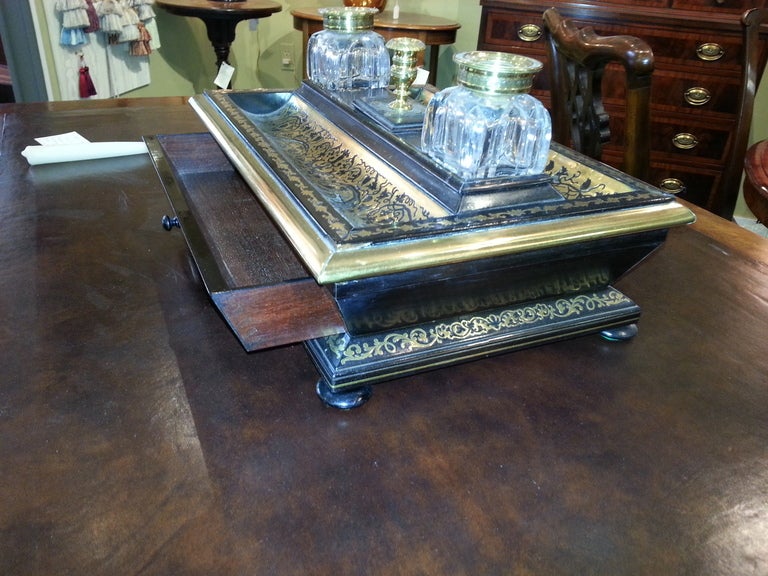 Fabulous English 19th cent Regency Boulle Standish in ebonized mahogany inlaid with brass. The Standish  has a single drawer as is on bun feet. The crystal inkwells have matching boulle tops. One inkwell is cracked on the bottom a s shown in the pic