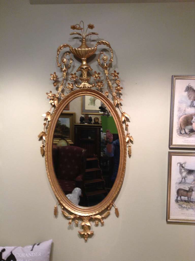 Beautiful Williamsburg Chippendale Style oval Gilt Mirror with extensive decoration.