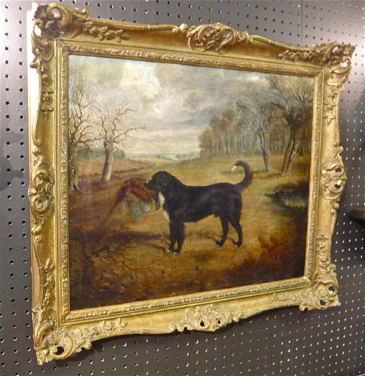 A 19th century English oil-on-canvas of a hunting dog with prey in a country landscape by W.J. Gilbert of Suffolk, England.  SIgned.  Mr. Gilbert is a listed artist of British sport, hunt and equestrian subjects.  He is listed in the Dictionary of