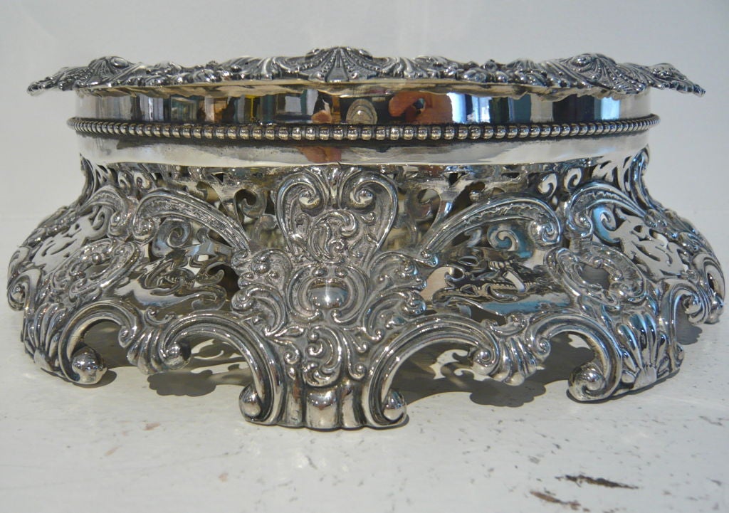 A beautiful, highly decorative, silverplate two-part centerpiece featuring an overall rococo design, applied scrolling border to top insert and filigreed base with beaded rim.  Very nice large scale.  Heavy weight.  Would make an elegant impact on a