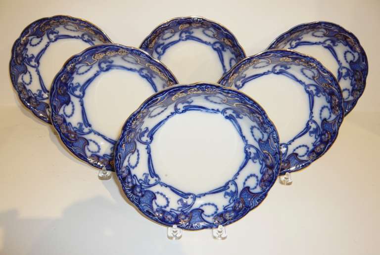 A lovely set of English Victorian flow blue soup plates with gold decoration in the Delamere pattern by Henry Alcock & Company Ltd., circa 1880.  Perfect for use or display.