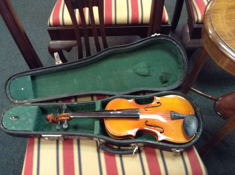 Beautifully made child's violin in hard leather original case. The case has a tin label which reads 