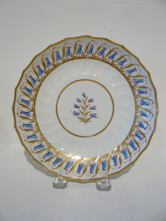 An elegant pair of early 19th century, delicately hand-painted, English porcelain plates with blue bellflowers, gilt trim and fluted rims.  One marked Barr Flight Barr (1807-1813), the renowned Worcester porcelain company.  Worcester porcelain was