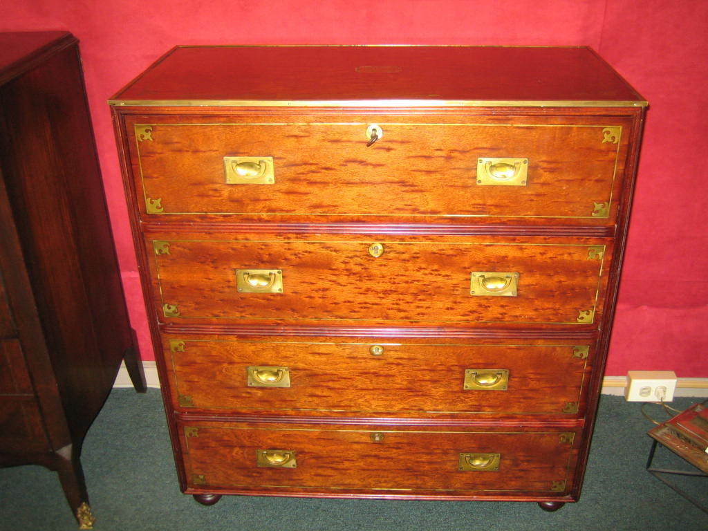 VERY HANDSOME CAMPAIGN/MILITARY STYLE 4 DRAWER CHEST IN BIRCH WITH EXTENSIVE BRASS INLAY SET ON BUN FEET. THE CHEST COMES WITH THE ORIGINAL KEY. THE TOP DRAWER OPENS TO REVEAL A SECRETARY WITH PIDGEON HOLES AND LEATHER WRITING SURFACE. THE TOP OF