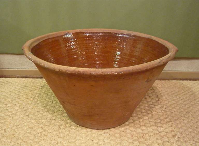 A very large English terracotta pancheron hallmarked by the maker, Cotswold Potteries Ltd of Gloucestershire England.

Overall dimensions are shown below.  Additional dimensions are as follows.  The base is 10.25 inches in diameter.