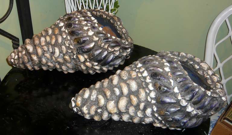 English sculptress Iris North revives a Victorian art form in these shell-encrusted planters.  North specifically selects seashells from Brighton Beach in West Sussex in the South of England, carefully composes them into the desired pattern, and