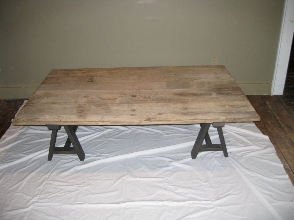 This saw horse leg coffee table has a vintage oak top made from reused barn wood.<br />
The top has been bleached to its new patina.