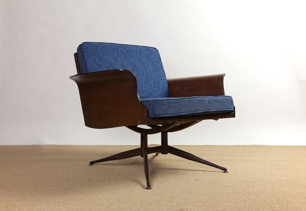 Low and very comfortable 1960's lounge chair with winged wooden arms and faux woodgrain-on-metal structure. Underseat support is spring-strap. Fabric is nubby wool in azure blue.
