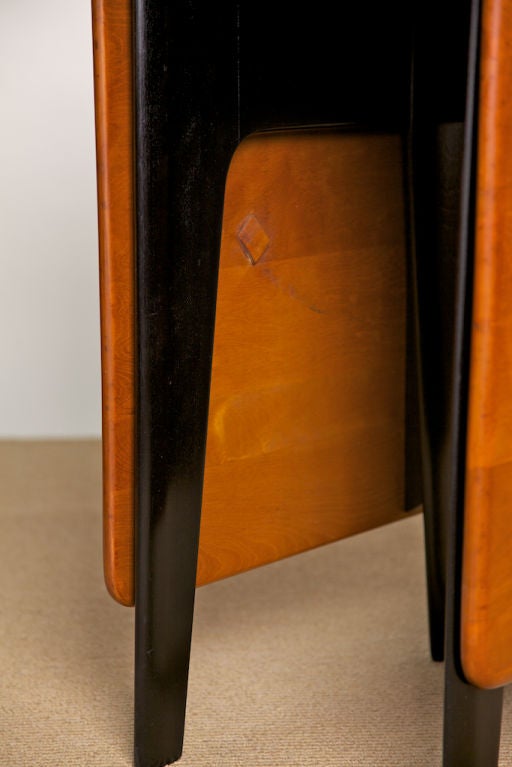 Heywood-Wakefield two-toned dining/worktable, perfect for a small space or NYC apartment. The shape of the legs are reminiscent of many of Jean Prouve's designs and most likely inspired by his work. Beautiful, rich woodgrain top, with black lacquer