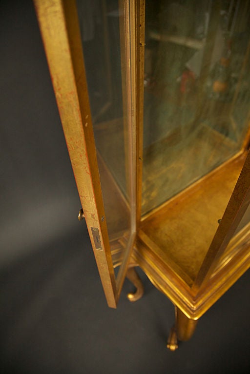 Gold-leaf over red paint, Wood and Glass Display or Curio Cabinet, with Queen Anne-style legs, two adjustable glass shelves included, sliding hidden shelf and two glass doors, one on either side.