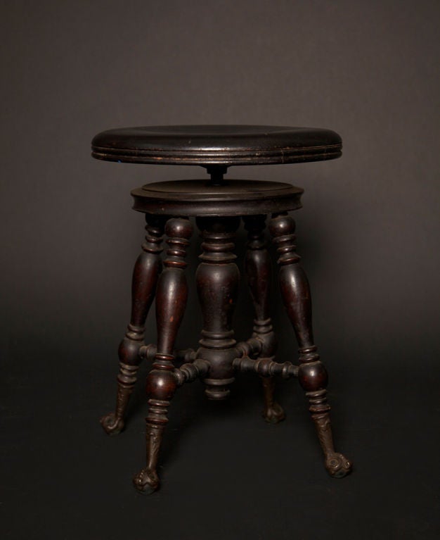 Beautifully detailed with rich mahogany patina, this piano stool has an adjustable-height seat with 