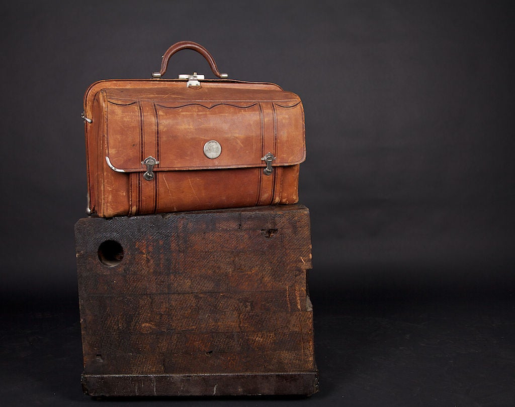 Red leather inside, brown outside with original metal accents. Fine detail makes a great window display piece for jewelry stores or other storefront displays. This is a great décor item in a home. Can also be used as a nostalgic weekend bag. Appears