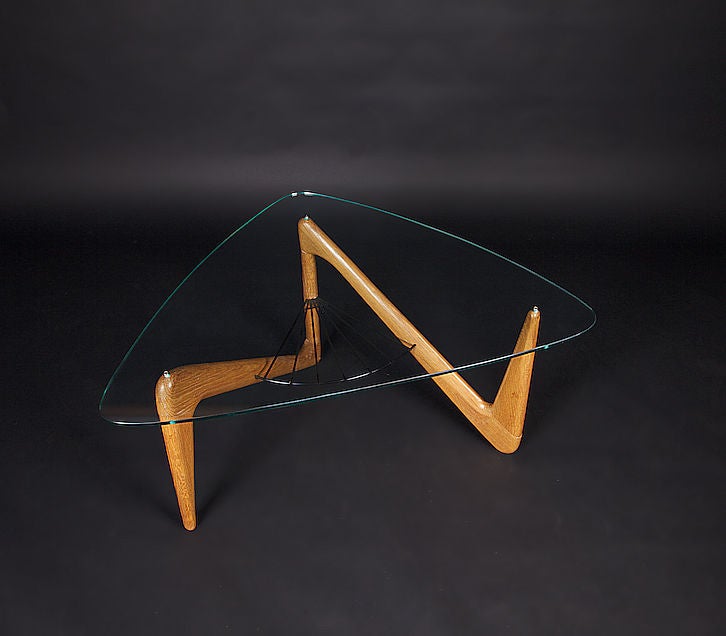 Louis Sognot Mid-Century coffee table, with beautifully finished solid oak triangle-inspired base. The glass is in perfect condition with no scratches or chips. Great organic eye-catching form with functionality, as the fan-shaped piece at the base
