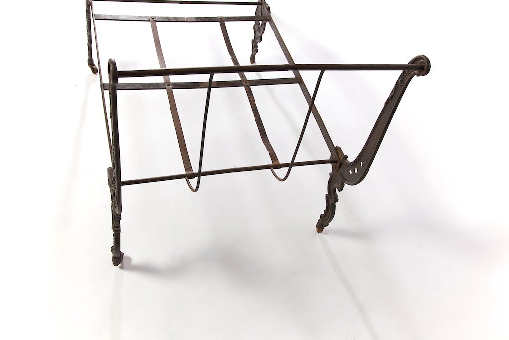 This is a Civil War cast iron folding cot, with its original finish intact, in sturdy condition with metal casters. It is missing a middle wheel but that doesn't affect its stability. Beautiful classic detail throughout this piece.

You can easily
