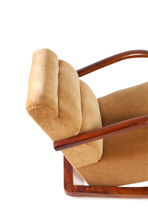 Pair of 1930 Art Deco Lounge chairs, with sensuous curved wooden base, rising up to form the arms of these 
