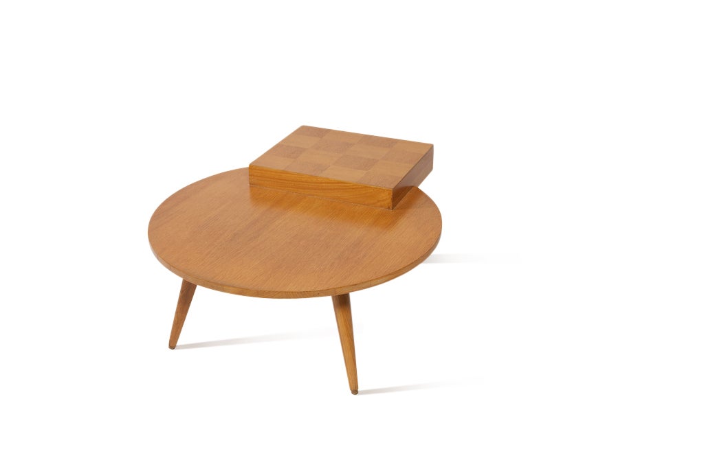 Circa 1956, this maple table sits low to the ground, and makes an eye-catching side table for a sofa or your favorite chair. We find it to be very unique, and we've never come across this structure of table before. Note the parquet inlay on the