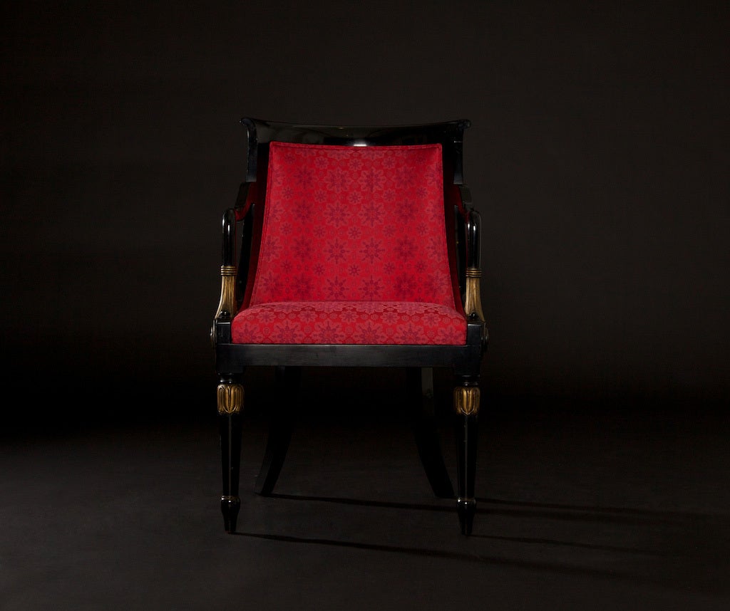 Lovely black-lacquered pair of Neo-Classical side chairs, with a striking silk-blend deep red upholstered fabric. Note the gold-leaf details of the arms, with the feather pattern, along with the gold-leaf 