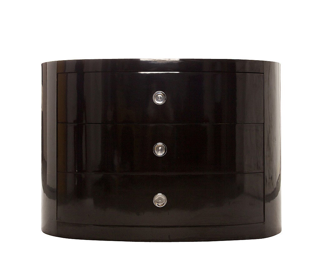 Modernist 1950 dresser, with beautiful, elegant lines and original Lucite knobs, in a deep piano black laminate. This three-drawer dresser is the epitome of 1950's modernism, in very good vintage condition and would be a wonderful show piece for a